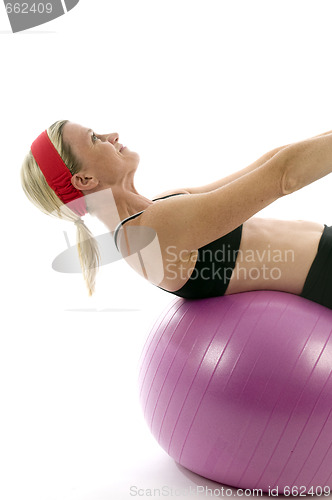 Image of sit ups strength pose middle age woman fitness core ball