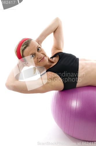 Image of   sit ups strength pose middle age woman fitness core ball