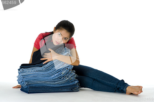 Image of young woman with her jeans collection