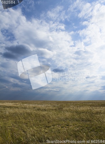 Image of Landscape - filed, the blue sky, white clouds and sun rays.