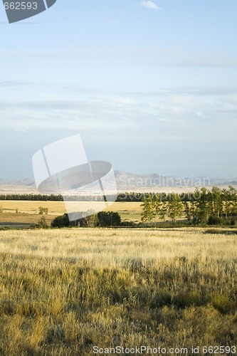 Image of Landscape with grass, meadow, trees, hills, mountain and cloudy 