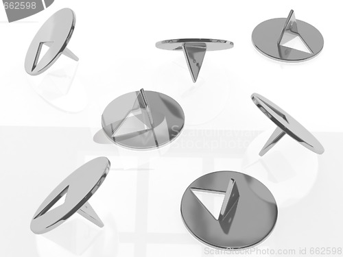 Image of metallic thumbtacks (drawing pins) on white background