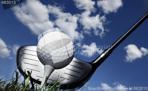 Image of Golf club and ball in grass