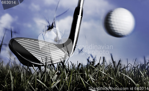 Image of Golf club and ball in grass