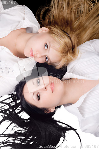 Image of Portrait of two lying beautiful young women