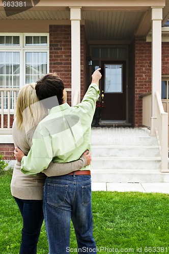 Image of Happy couple in front of home