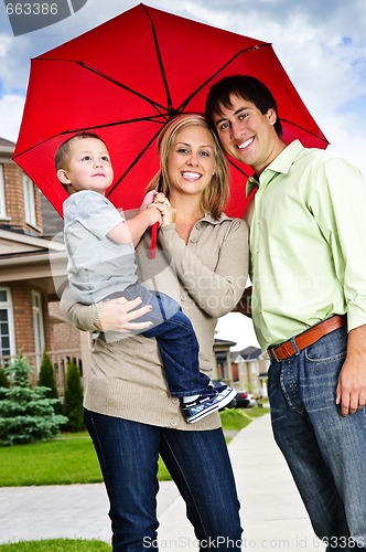 Image of Happy family with umbrella