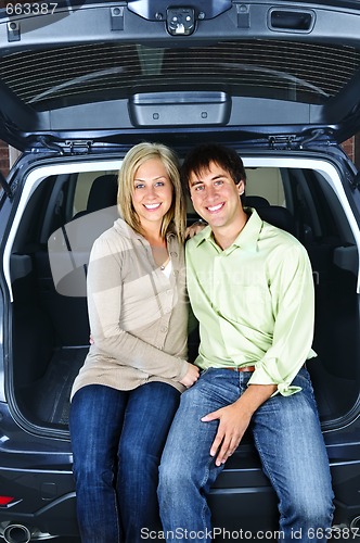Image of Couple sitting in back of car