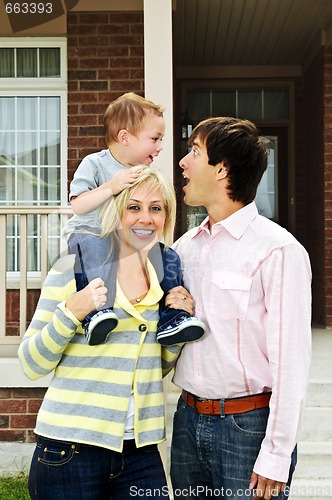 Image of Happy family in front of home