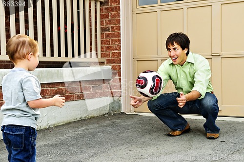 Image of Father and son playing soccer