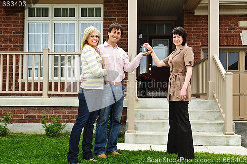 Image of Happy couple with real estate agent