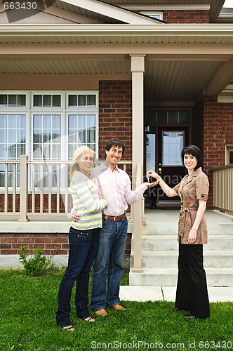 Image of Happy couple with real estate agent