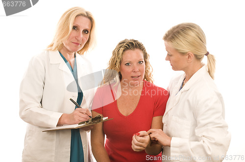 Image of two doctors nurses in medical scrubs clothes with patient