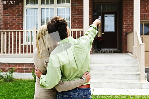 Image of Happy couple in front of home