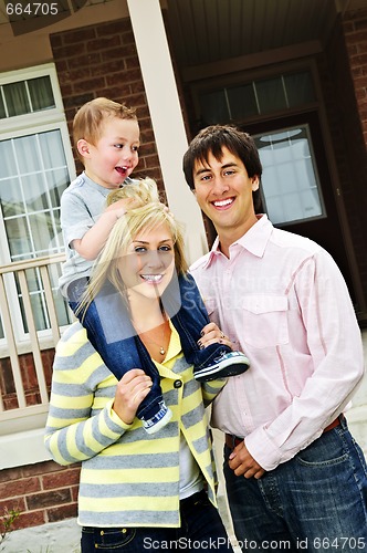 Image of Happy family in front of home