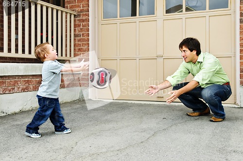 Image of Father and son playing soccer