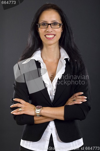 Image of attractive businesswoman standing with hands crossed