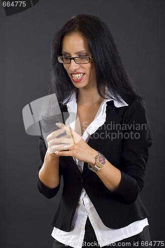 Image of picture of a businesswoman looking at a phone smiling