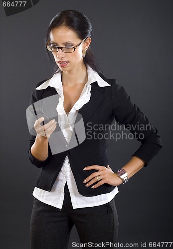 Image of picture of a businesswoman looking at a phone