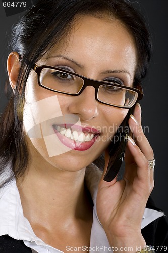 Image of closeup of an attractive businesswoman on the phone over black background