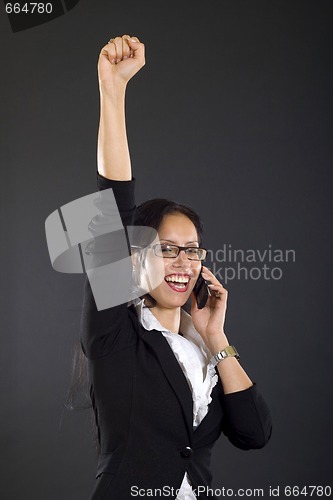 Image of attractive businesswoman on the phone winning over black background