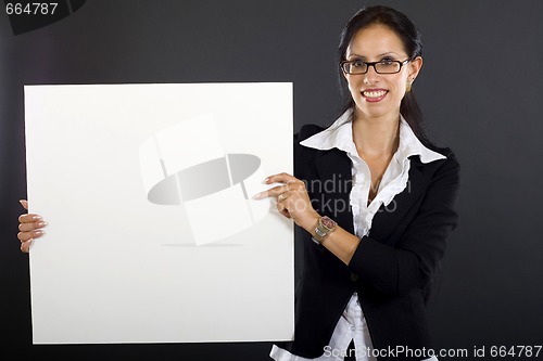 Image of attractive businesswoman presenting a blank board