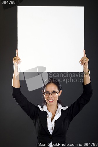 Image of  attractive businesswoman holding a blank board over her head