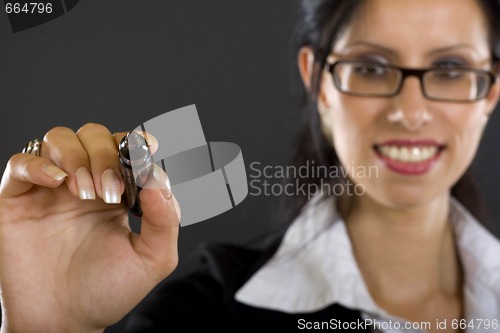 Image of attractive businesswoman with marker over black background