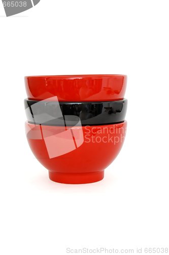 Image of Stack of two red and one black porcelain bowls isolated