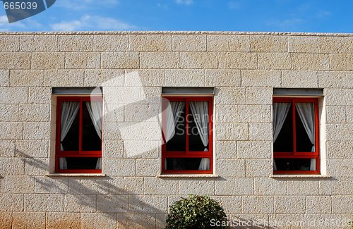 Image of Stone wall of the house with three windows