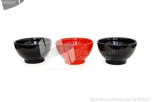 Image of Row of two black and one red porcelain bowls isolated