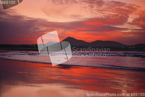 Image of orange sunset in playa Famara, Lanzarote