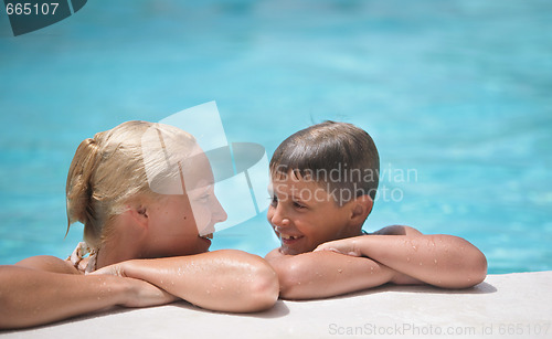 Image of happy boy and mom in the swimming pool