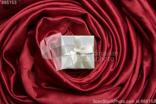 Image of White gift box on red silk