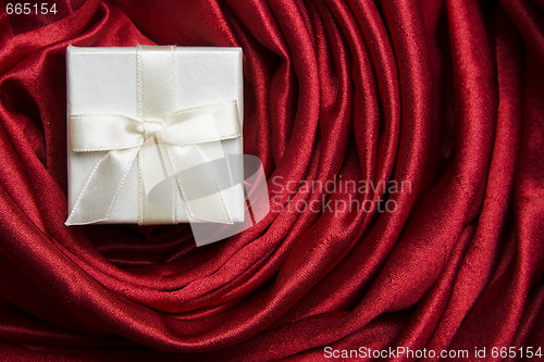 Image of White gift box on red silk