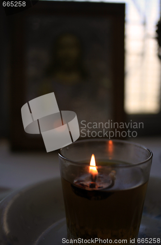 Image of Candle and icon in church