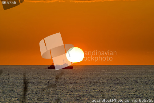 Image of Sunset with a boat