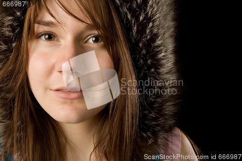 Image of serious young woman in fur hat