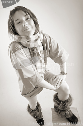 Image of young happy woman in striped muffler