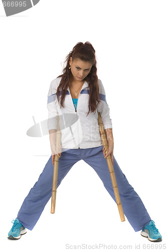 Image of athletic woman with sticks