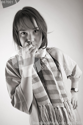 Image of thoughtful young woman in striped muffler