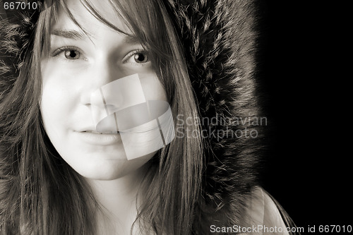 Image of serious young woman in fur hat