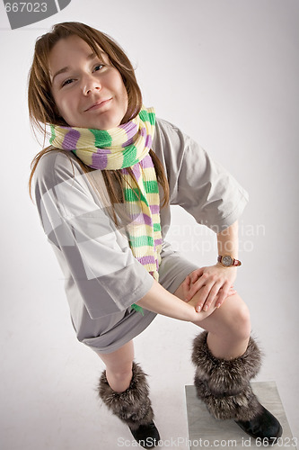 Image of young happy woman in striped muffler