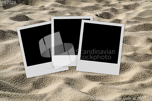 Image of Empty photo frames  on sand background