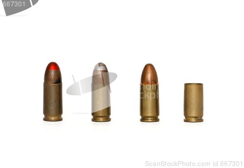 Image of Row of three 9mm cartridges and spent case isolated 