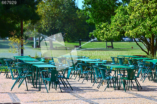 Image of empty tables in street cafe