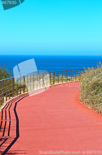 Image of Bicycle lane road on red asphalt road in the city park