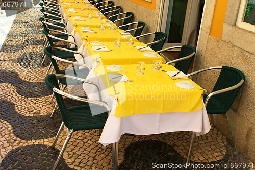 Image of empty tables in street cafe