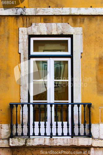 Image of window in old yellow wall