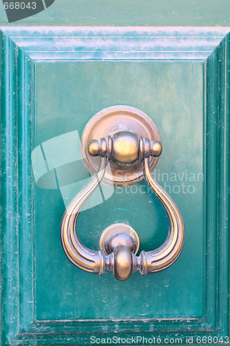 Image of an old metal door handle knocker